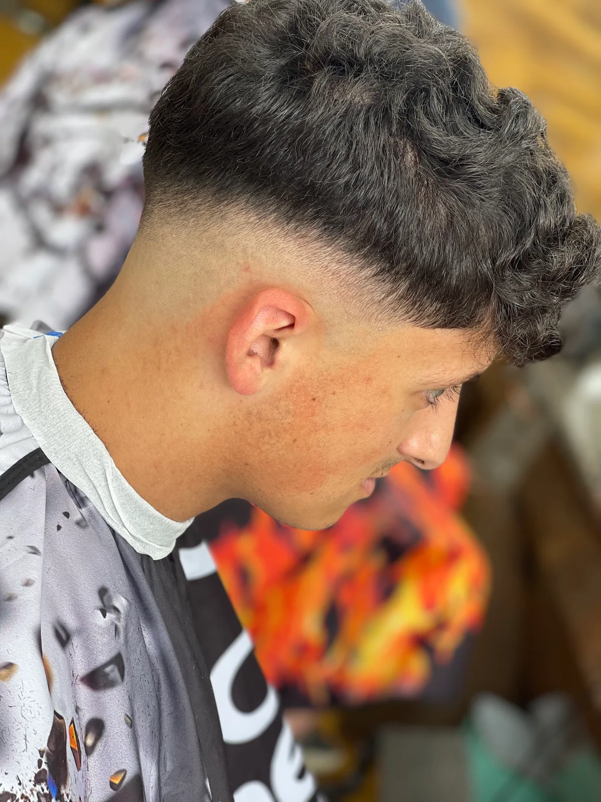 A finished skin fade with short curls at Cutting Crew
