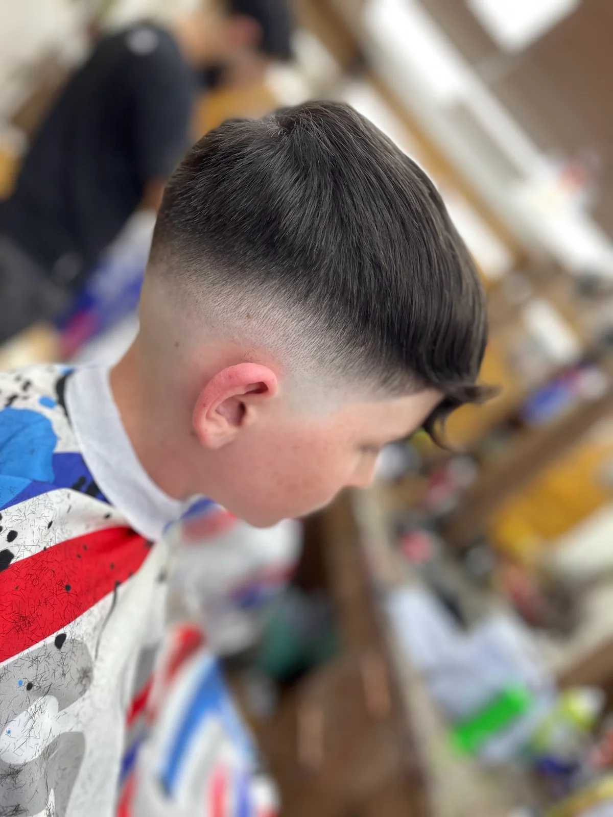 A neat side-parted haircut finished in the Otley shop